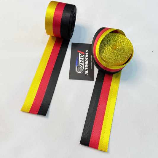 Aftermarket German flag tricolor seat belt webbing.