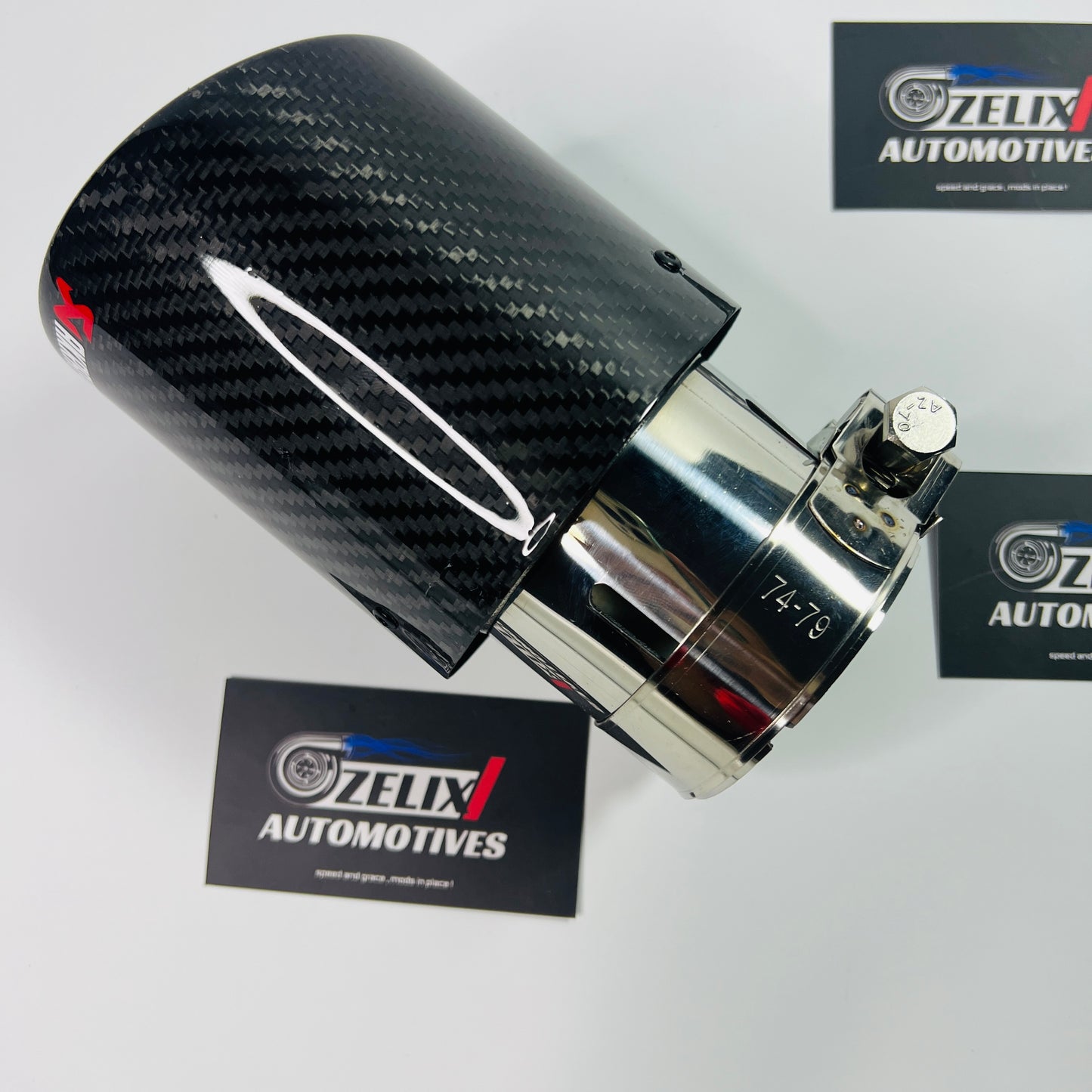 Top-down shot showcasing the round mouth outlet and glossy carbon finish