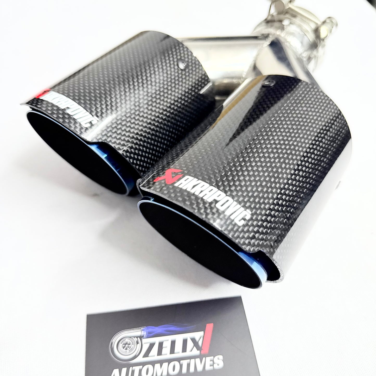 Top-down view emphasizing the gloss carbon fiber body and burnt titanium tips