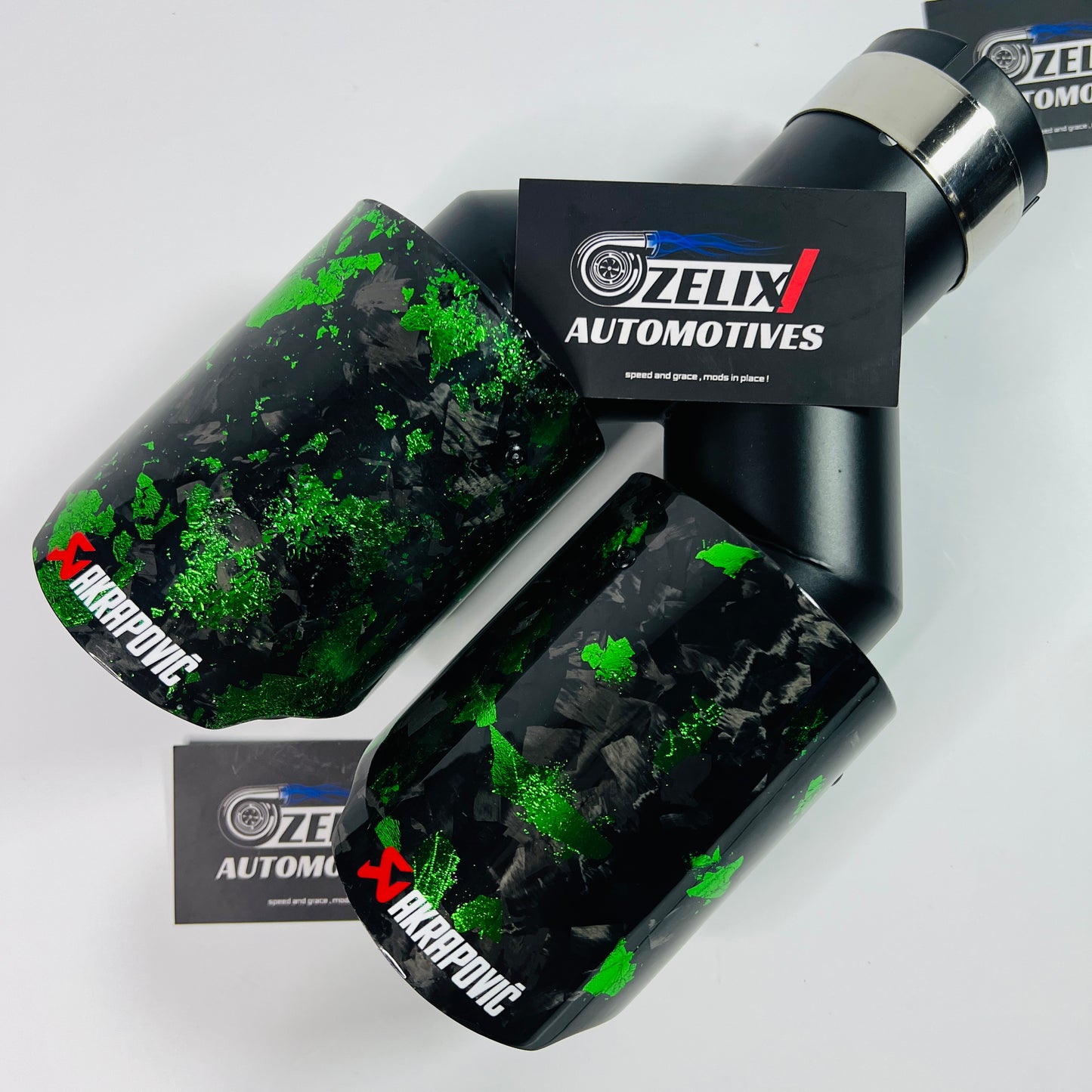 Akrapovic green forged carbon dual exhaust tip displayed from front angle