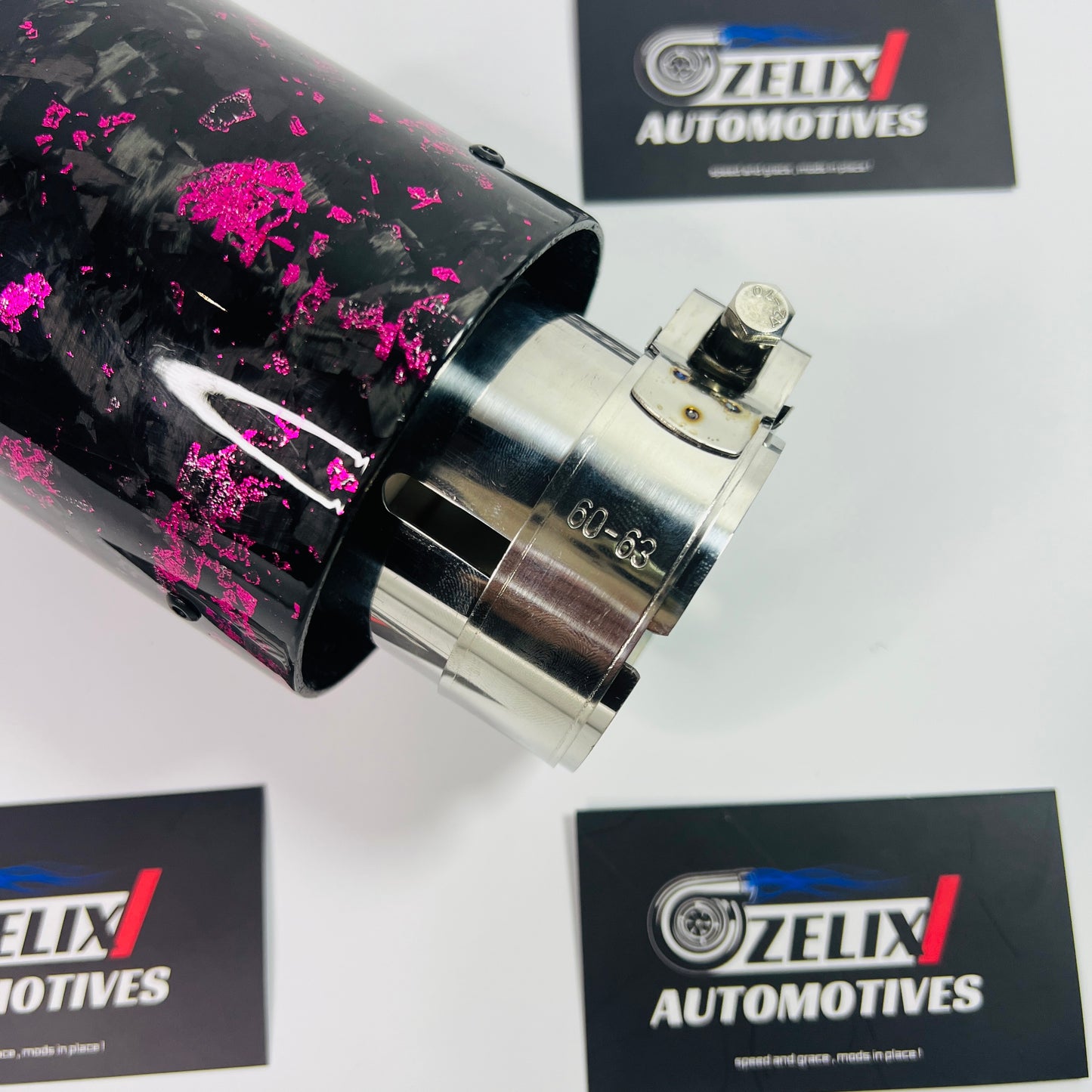 Close-up detail of the intricate pink forged carbon pattern and clear gloss finish on the tip.