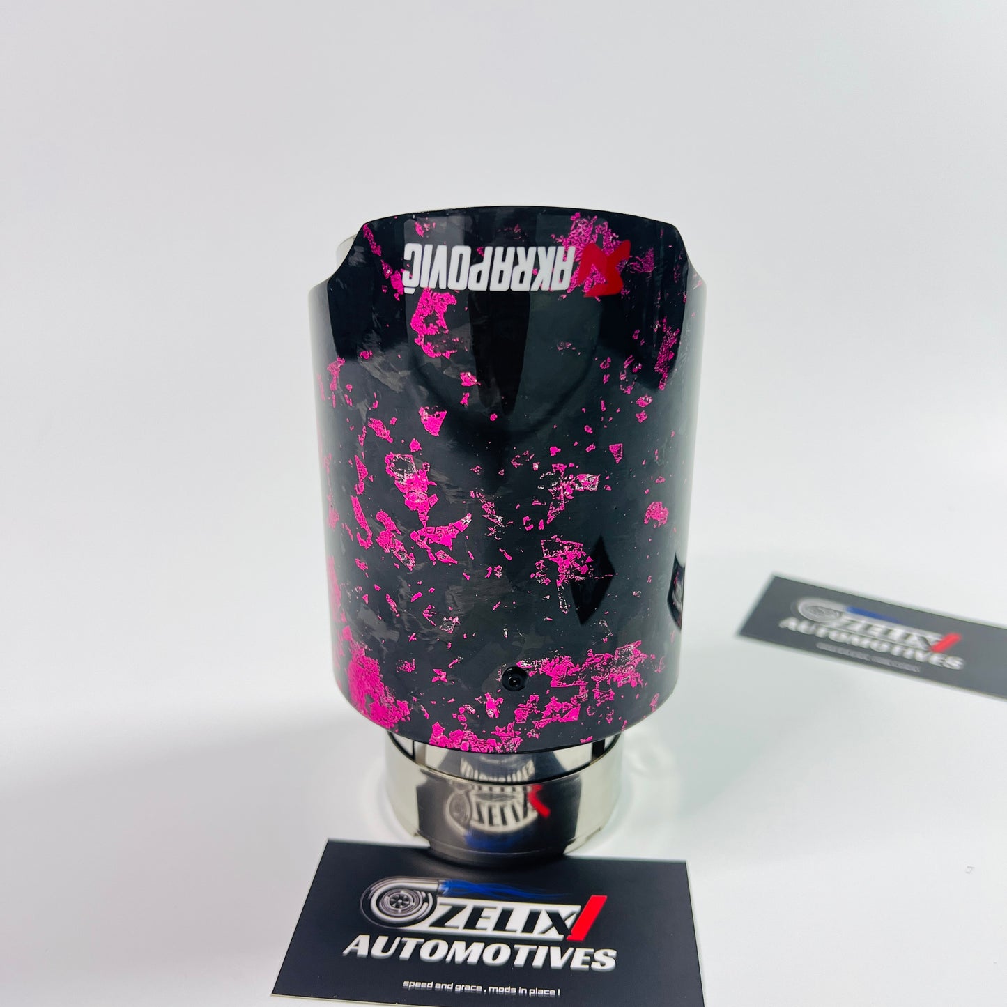 Side profile view showcasing the stainless-steel inlet and the striking pink forged carbon fiber texture.