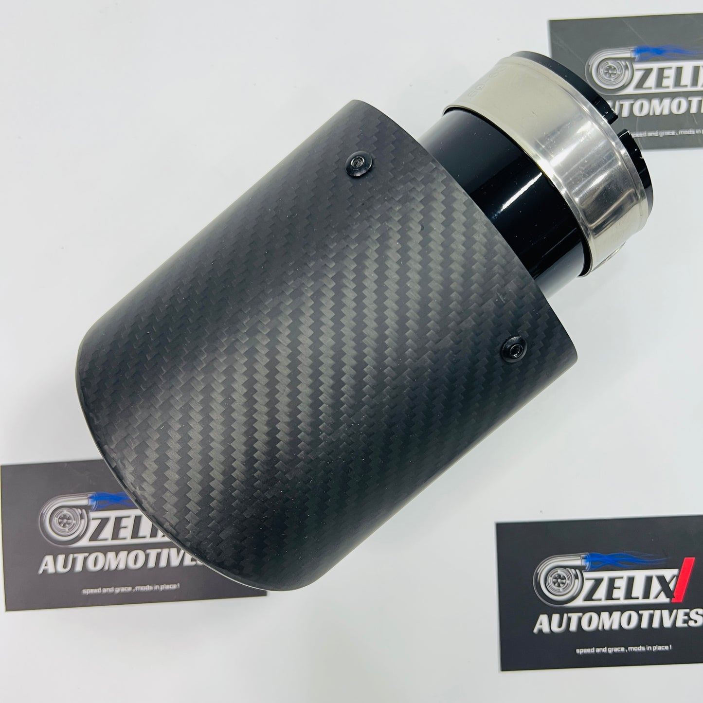 Single tip matte carbon black body exhaust tip shown from the front angle