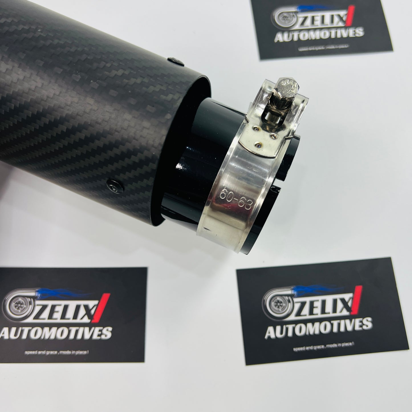 Top-down shot showcasing the round outlet and uniform matte carbon surface