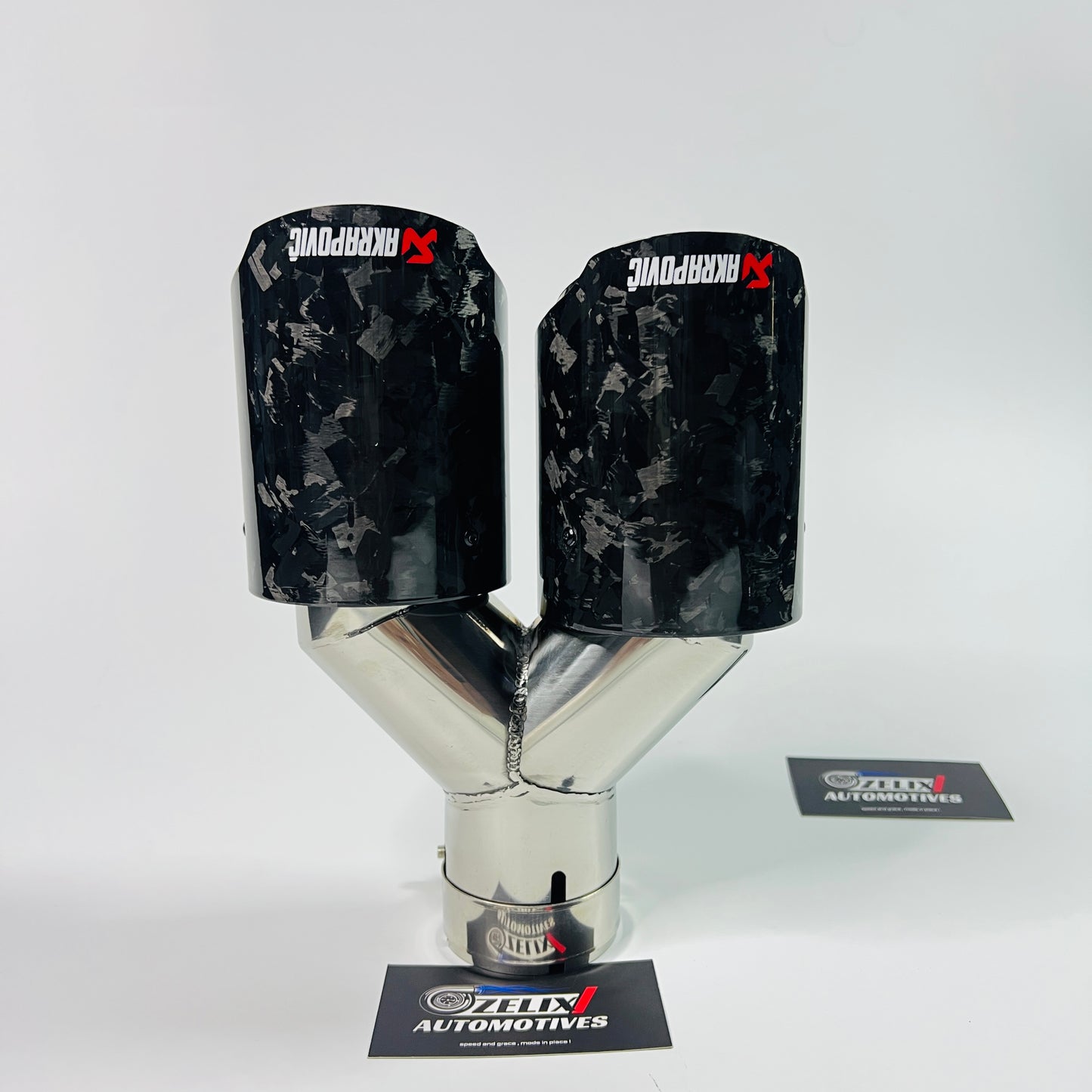 Akrapovic black forged carbon dual exhaust tips installed on car
