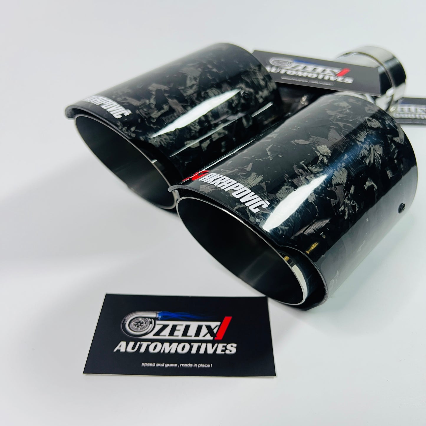 Side view of Akrapovic black forged carbon dual tips