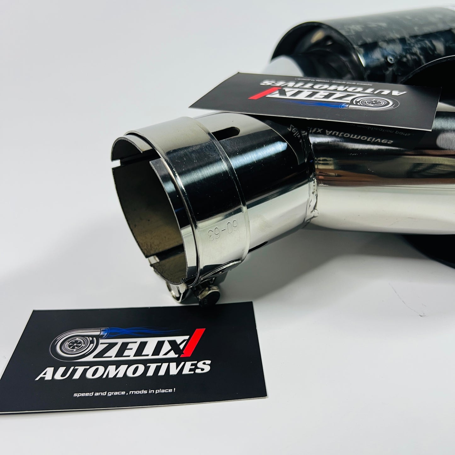 Close-up of black forged carbon texture on Akrapovic dual tips