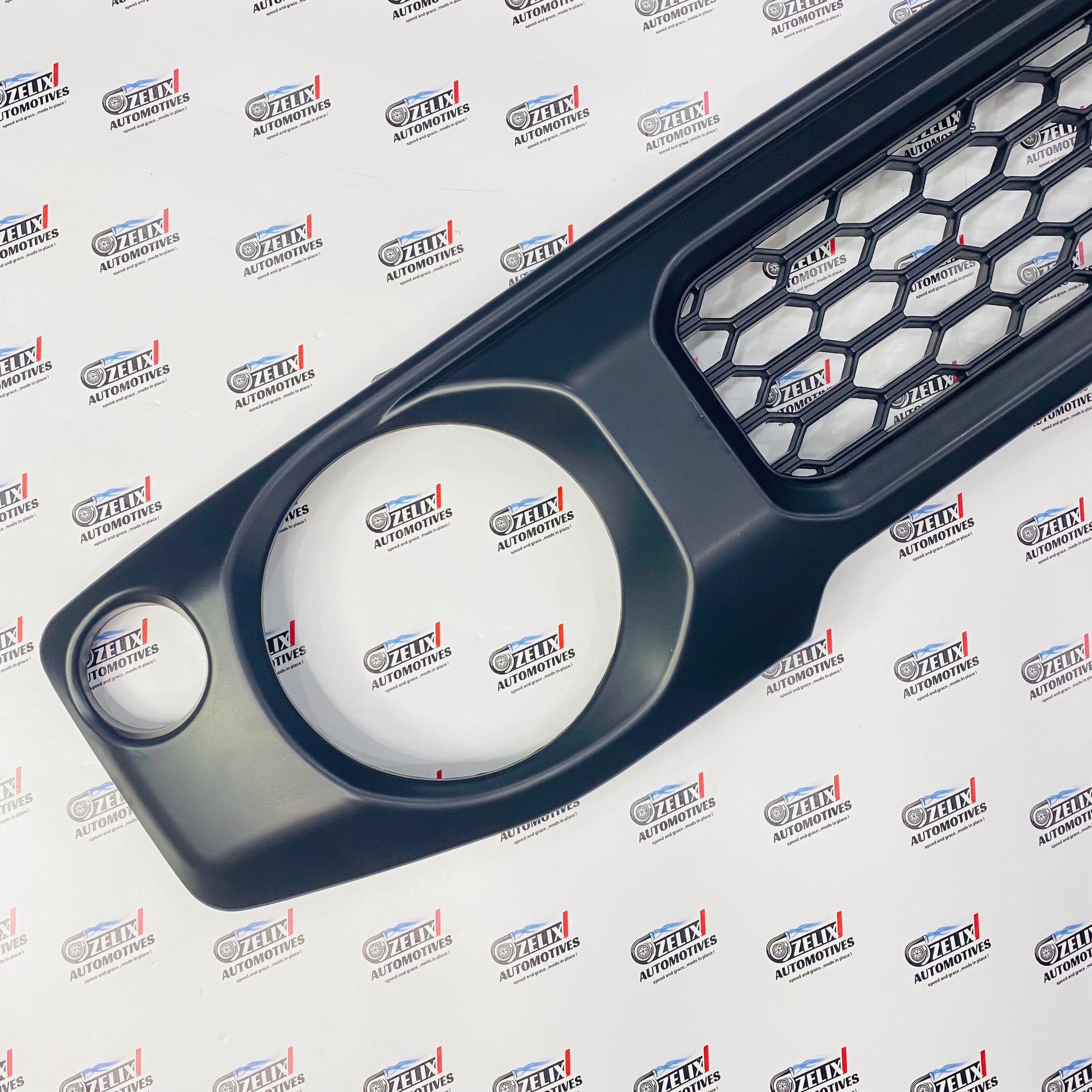 Aftermarket Jimny  front grille with cursive logo design 