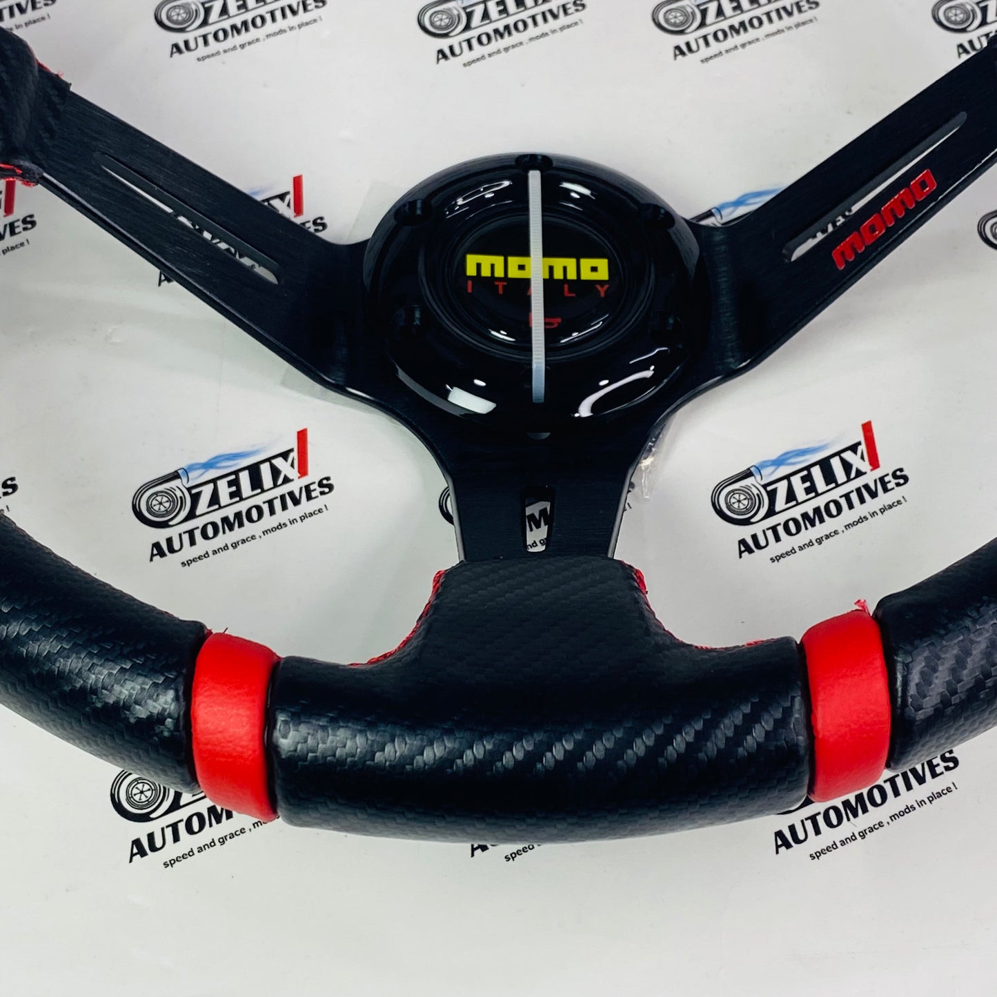 MOMO steering with carbon fiber grip and red color stitching