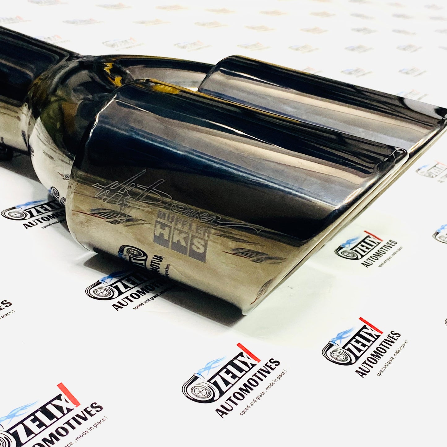 Glossy black HKS dual exhaust tip with 3 inch 