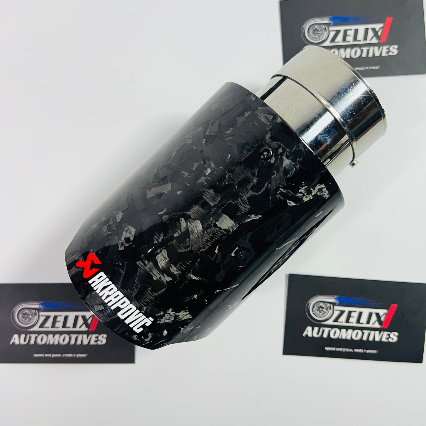 Akrapovic black forged carbon single exhaust tip displayed from the front angle
