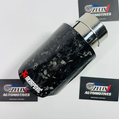 Akrapovic black forged carbon single exhaust tip displayed from the front angle