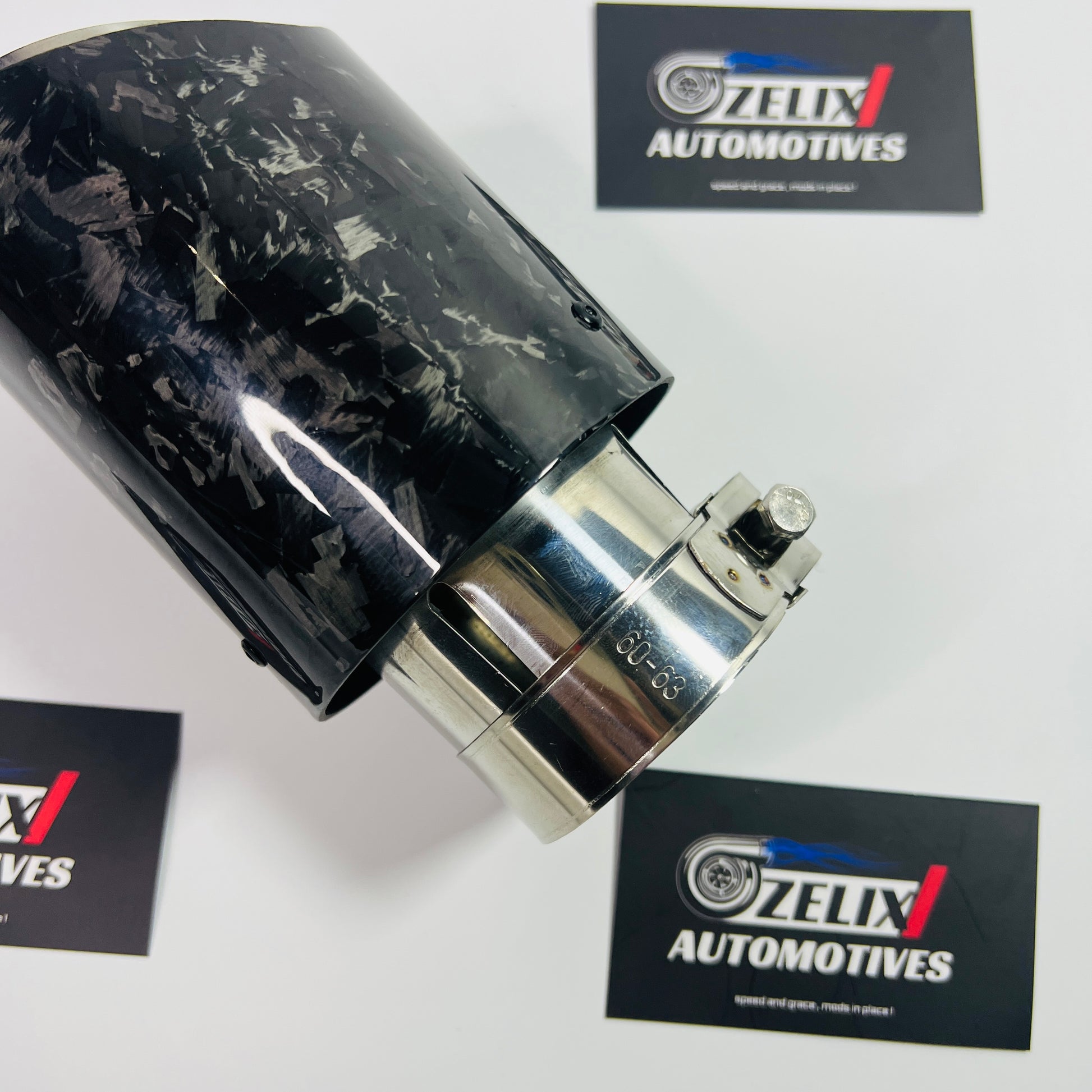 Side profile showcasing the polished stainless steel inlet and black forged carbon finish