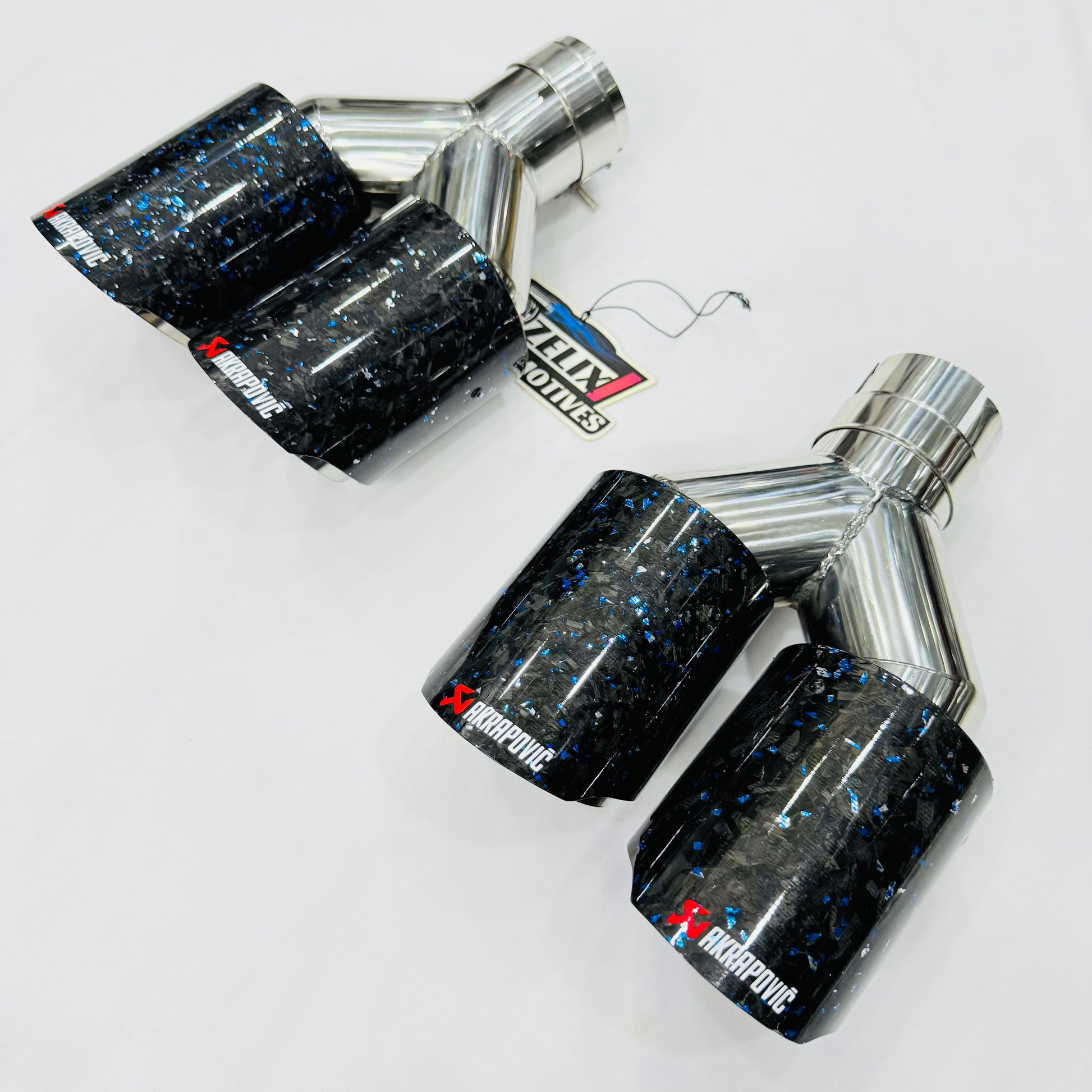 Akrapovic blue forged carbon dual exhaust tip—front display view