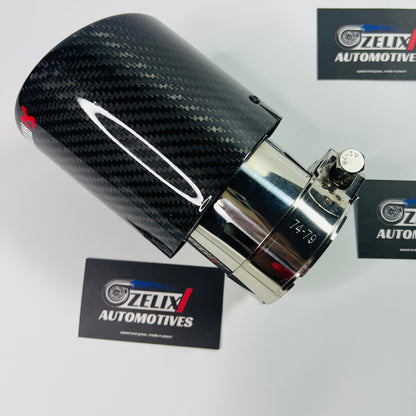 Top-down shot showcasing the round mouth outlet and glossy carbon finish
