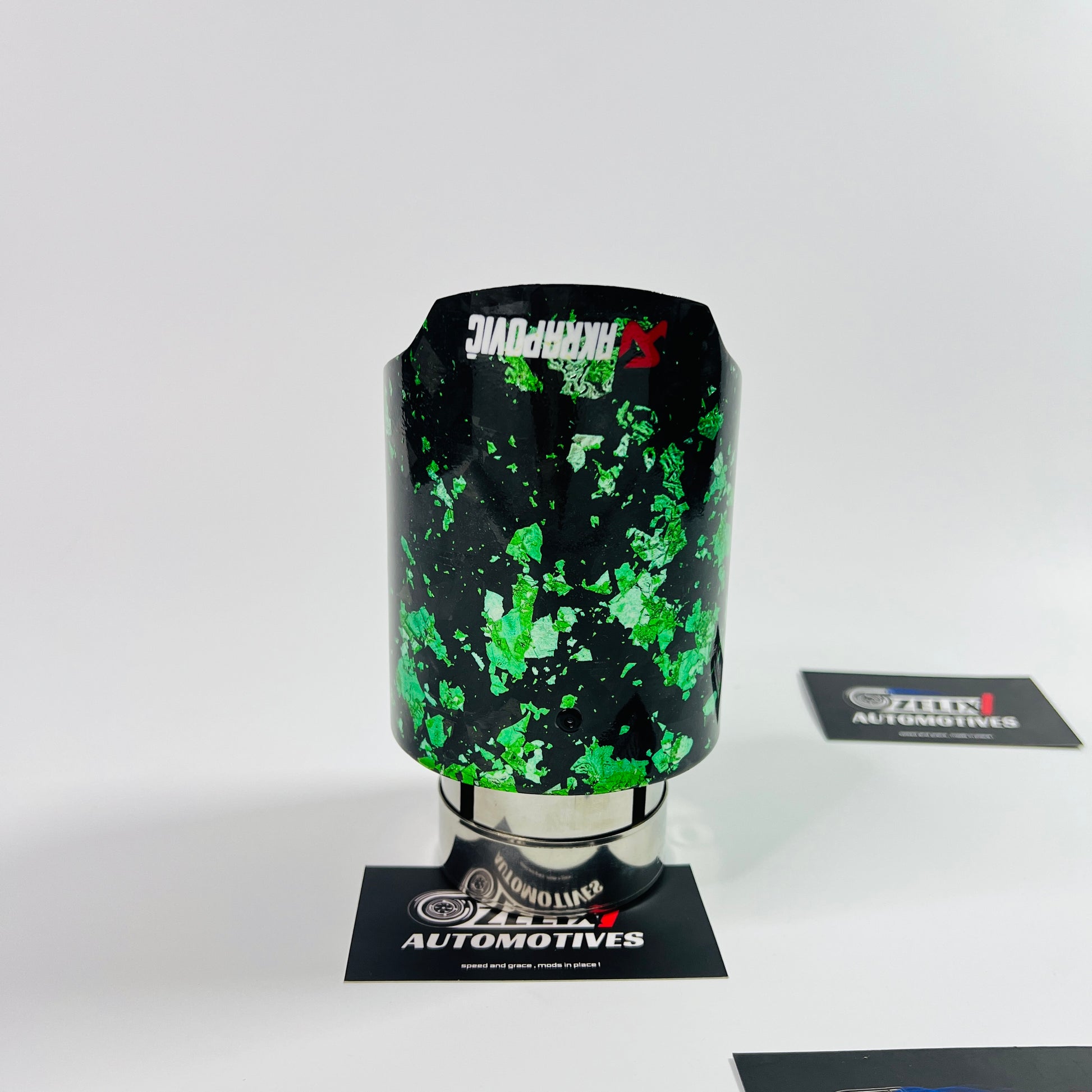 Side profile showcasing the vibrant green forged carbon texture and stainless‑steel core