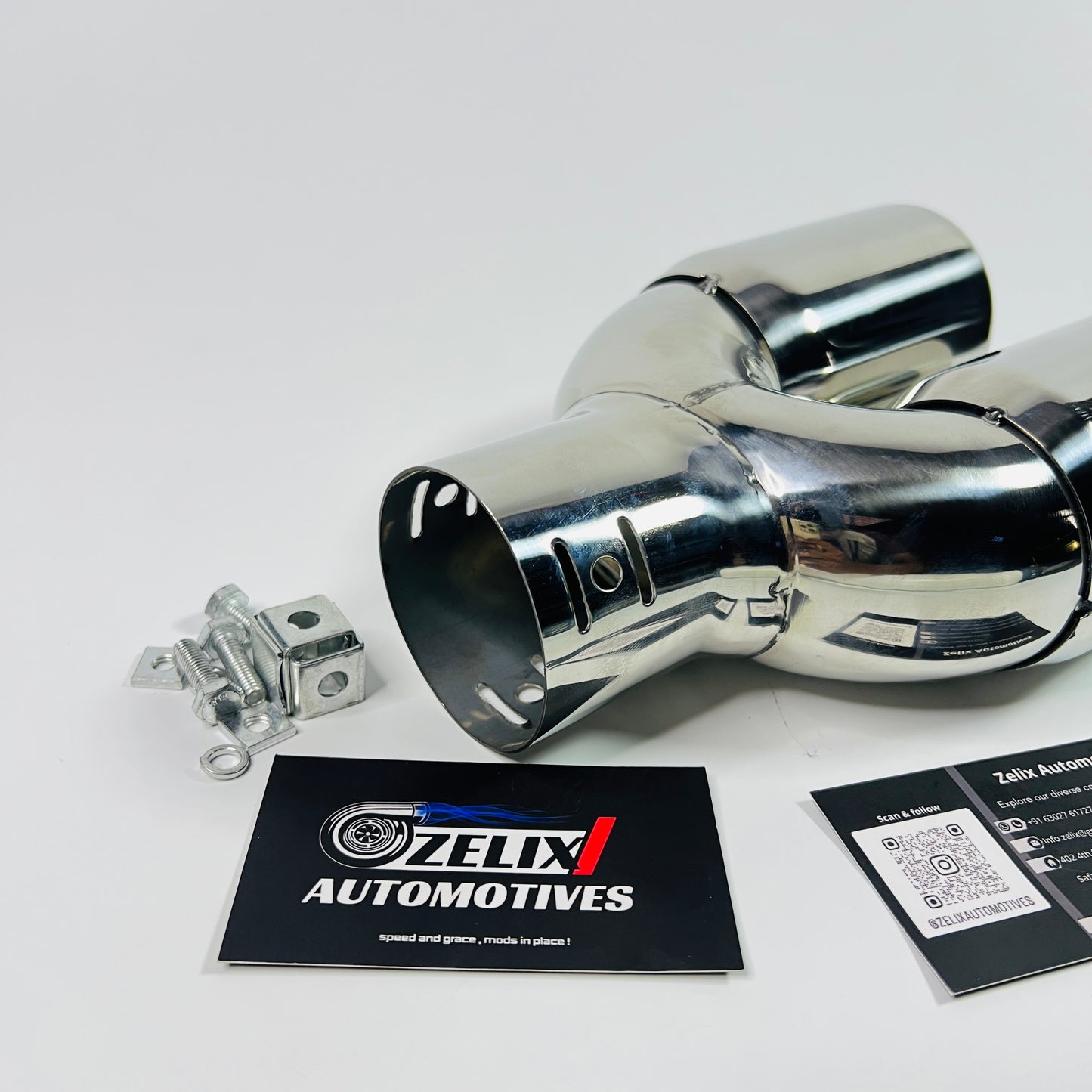 Angled side view showing the polished dual round outlets of the exhaust tip