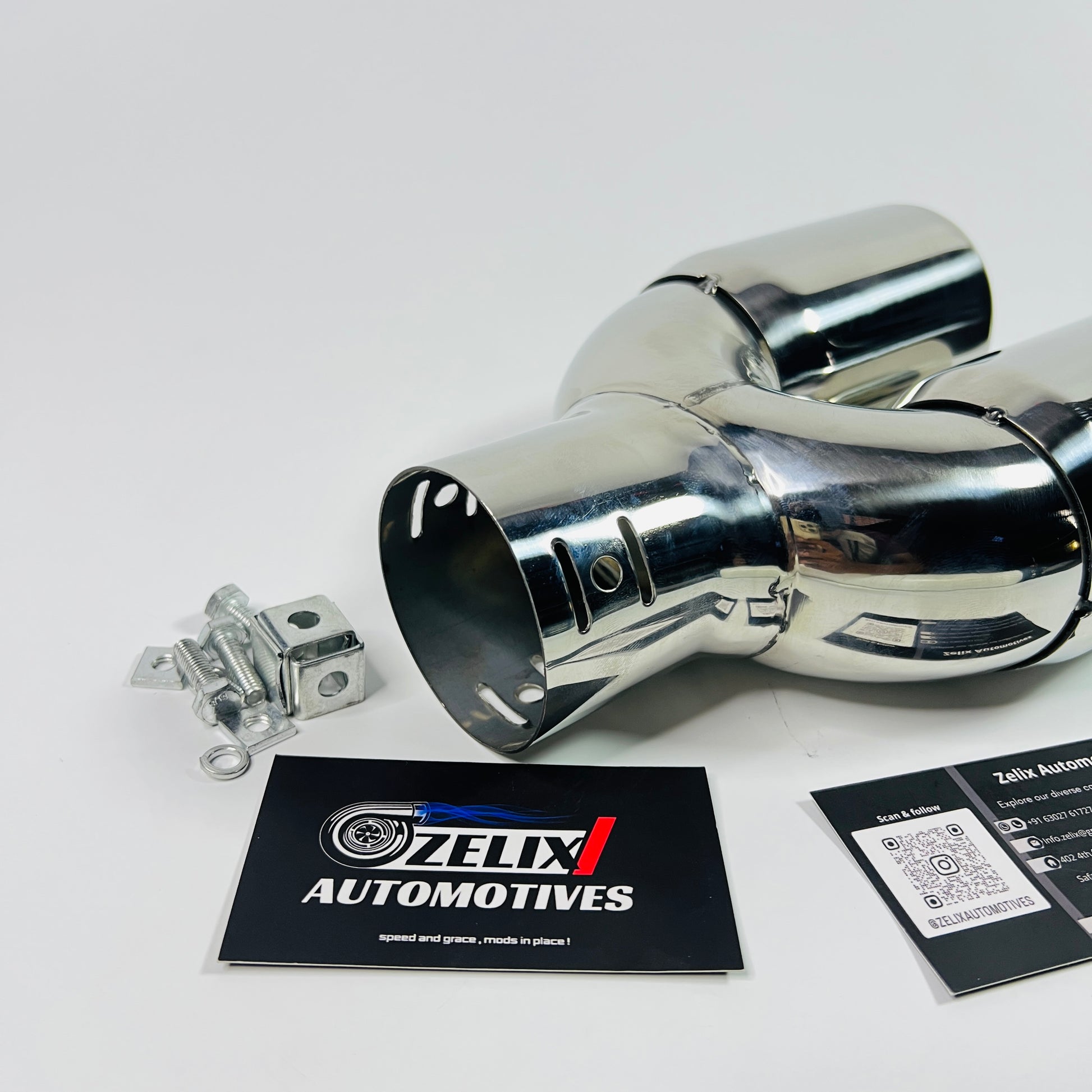 Angled side view showing the polished dual round outlets of the exhaust tip