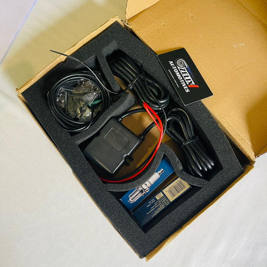 Zelix exhaust flame thrower kit components neatly arranged including module, spark plug, wiring, and remote switch
