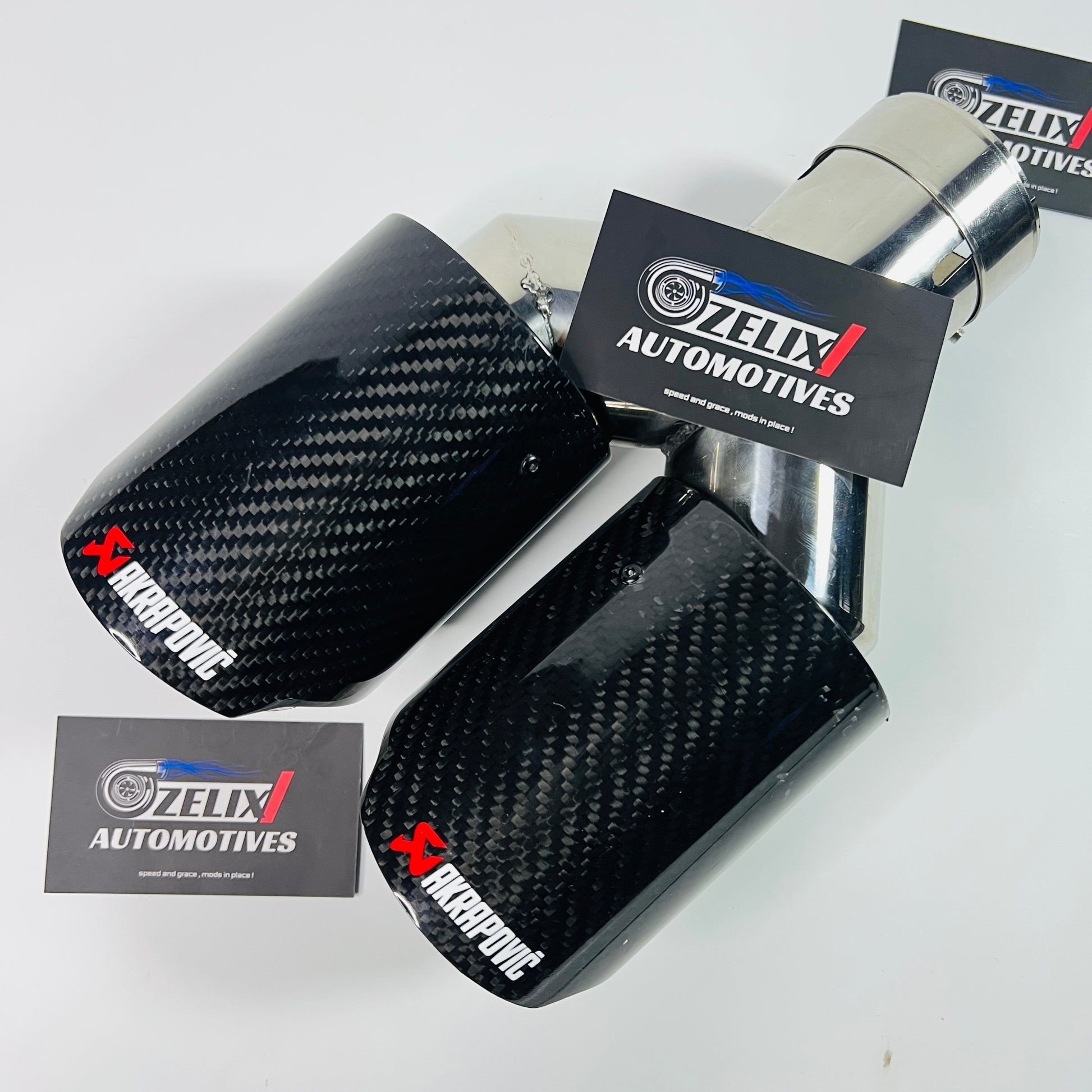 Akrapovic gloss carbon dual exhaust tip in low-light view