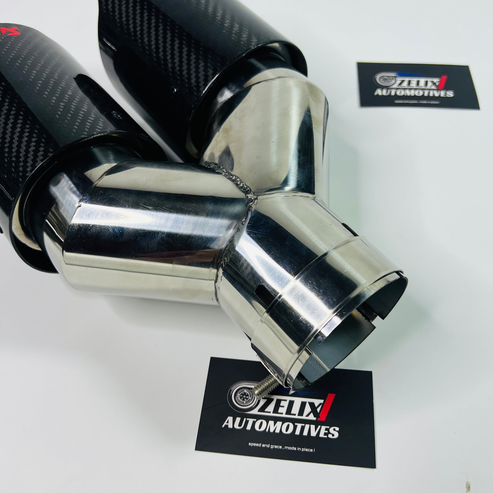 Akrapovic gloss carbon dual exhaust tip installed on car