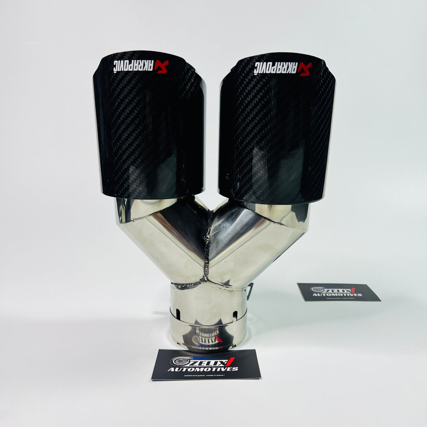 Side view of Akrapovic gloss carbon dual exhaust tip