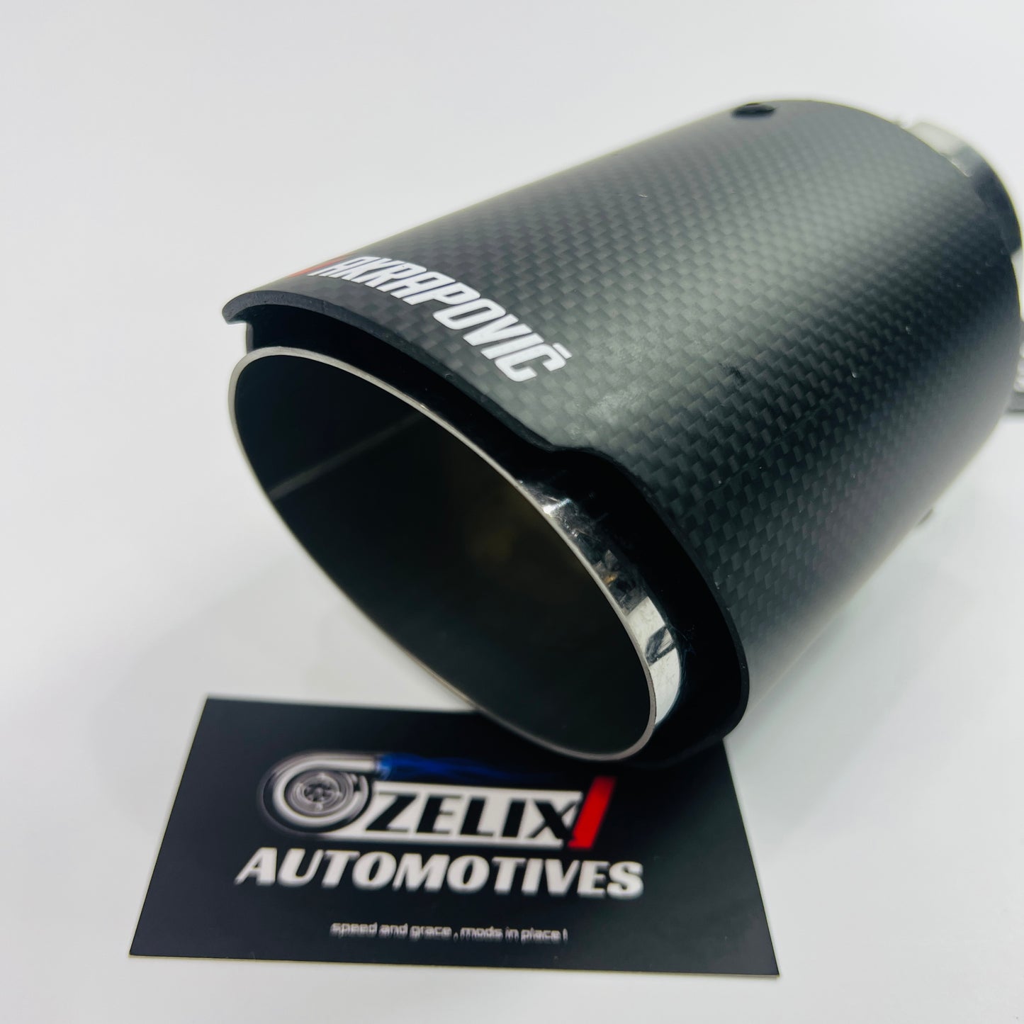 Akrapovic matte carbon single exhaust tip installed on car