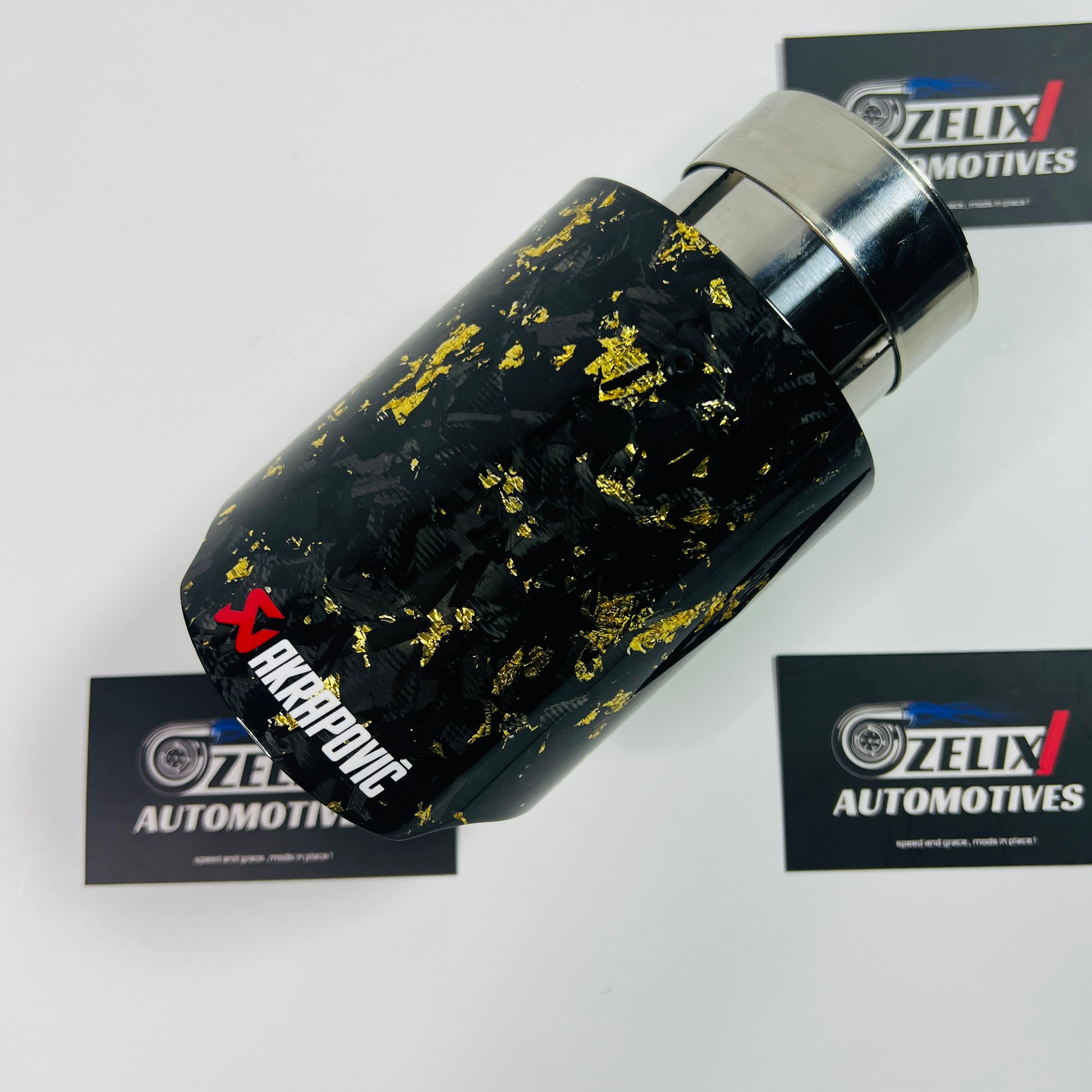Angled view of Akrapovic yellow forged carbon single exhaust tip