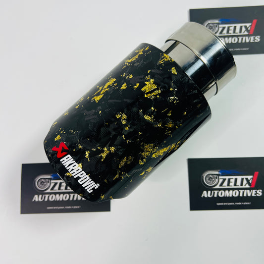 Angled view of Akrapovic yellow forged carbon single exhaust tip