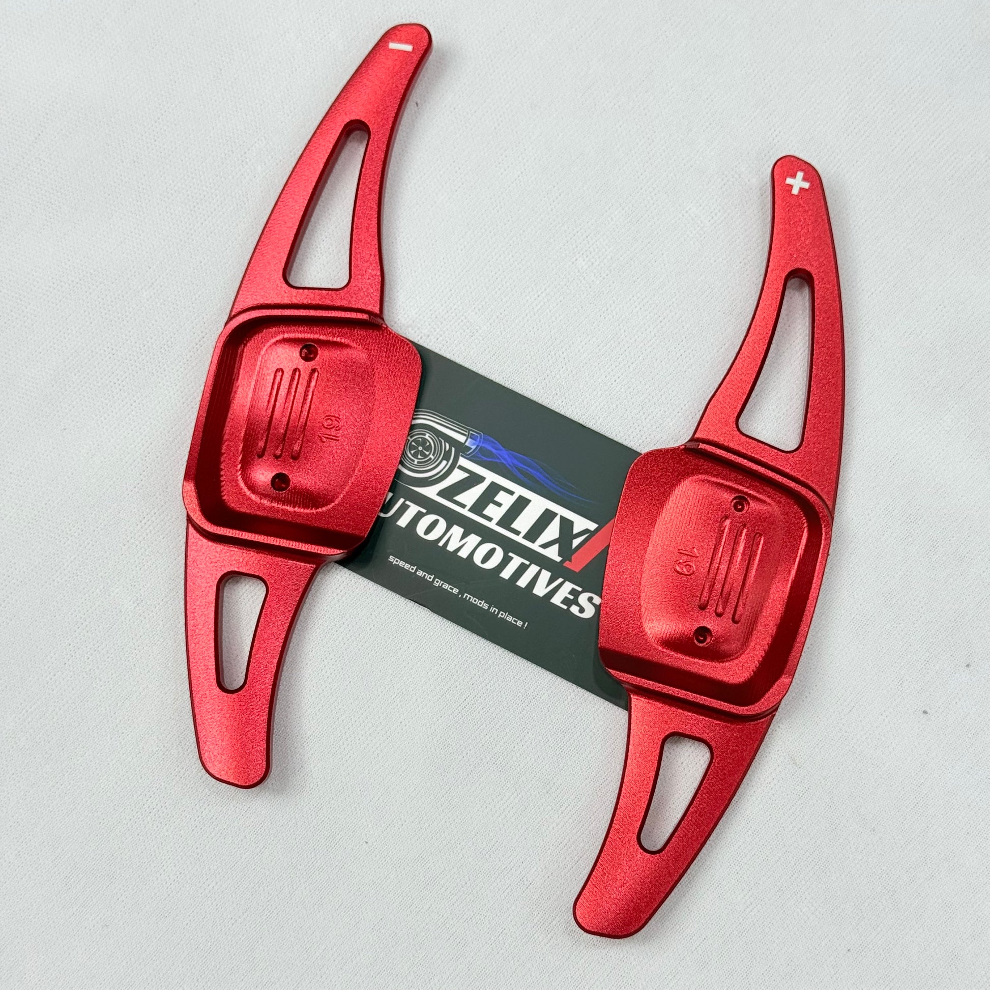 Close-up of red Virtus paddle shifter extender showing premium finish