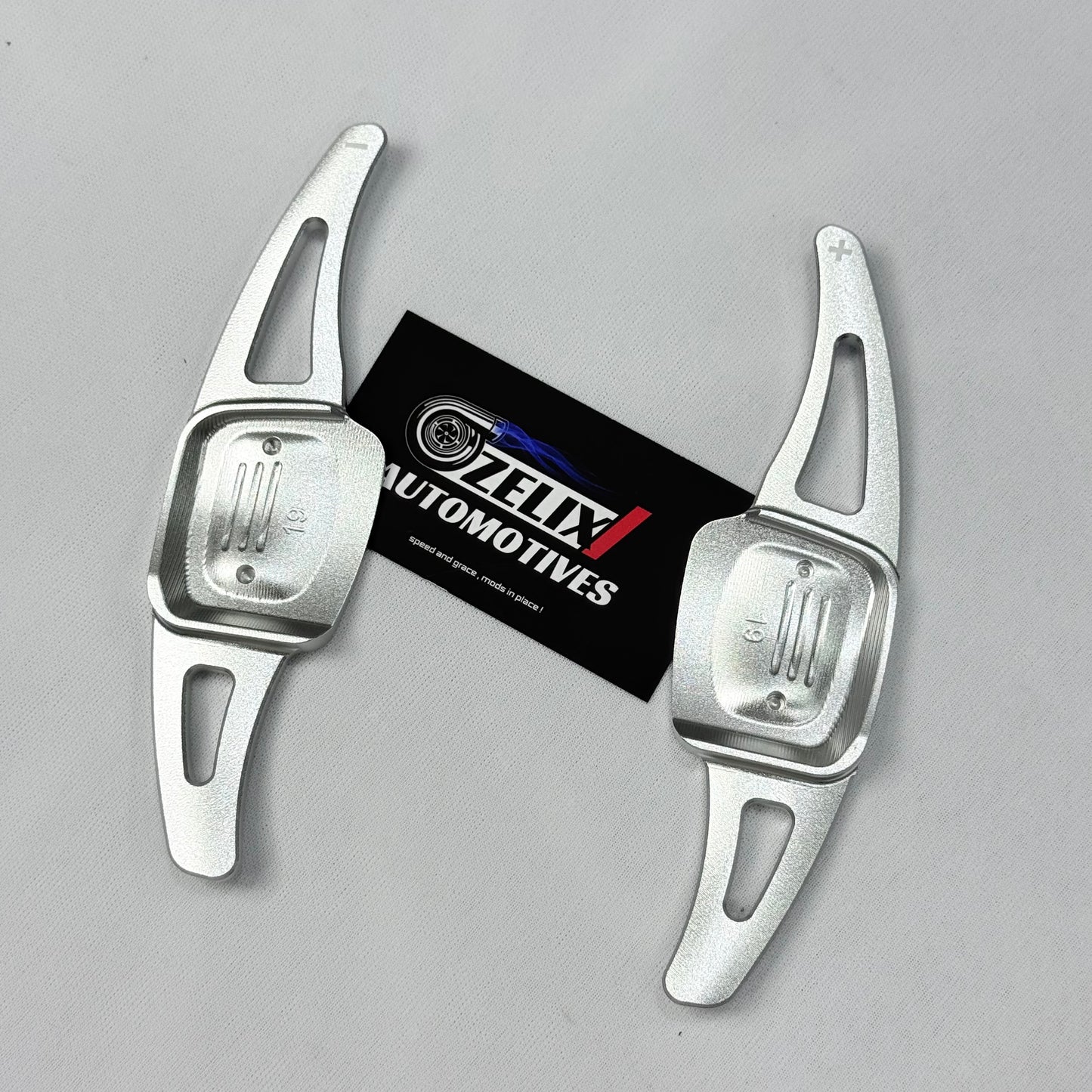 Front view of silver aftermarket paddle shifter extender for Volkswagen Virtus